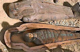 An ancient wooden coffin shaped like a human body and the mummy inside that date back to the 26th Pharaoh Dynasty that ruled from 672 BC to 525 BC, are seen in Sakkara, south of Cairo Wednesday, March 2, 2005. Australian archaeologists have discovered one of the best preserved ancient Egyptian mummies dating from about 2,600 years ago, Zahi Hawass, the head of Egypt's Supreme Council for Antiquities said. (AP Photo/Amr Nabil)