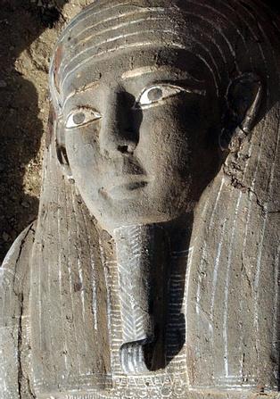 The face of an ancient wooden coffin, shaped like a human body that dates back to the 26th Pharaoh Dynasty that ruled from 672 BC to 525 BC, is seen in Sakkara, south of Cairo Wednesday, March 2, 2005. Australian archaeologists have discovered one of the best preserved ancient Egyptian mummies dating from about 2,600 years ago, Zahi Hawass, the head of Egypt's Supreme Council for Antiquities said. (AP Photo/Amr Nabil)