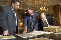 Todd Hickey, curator of the Center for Tebtunis Papyri, Anthony Bliss, curator of rare books and manuscripts at the Bancroft Library, and Donald M. Mastronarde, director of the Tebtunis center, examine papyri recently returned from Oxford. (Photos by Steve McConnell/UC Berkeley)