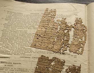 Fragments of papyrus rest in pages from back issues of the Oxford University Gazette (in this instance, the 15 July 1931 edition) in which they were shipped back from England.